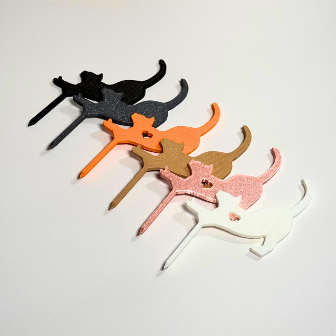 Cat plant stakes shown in six color variations in a stretching pose