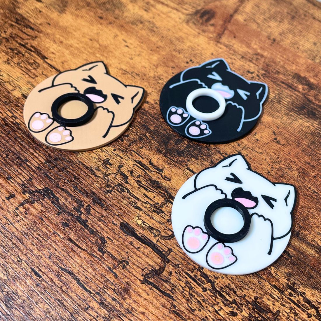 Cute chonk cat lip balm stands in three colors including beige, white, and black