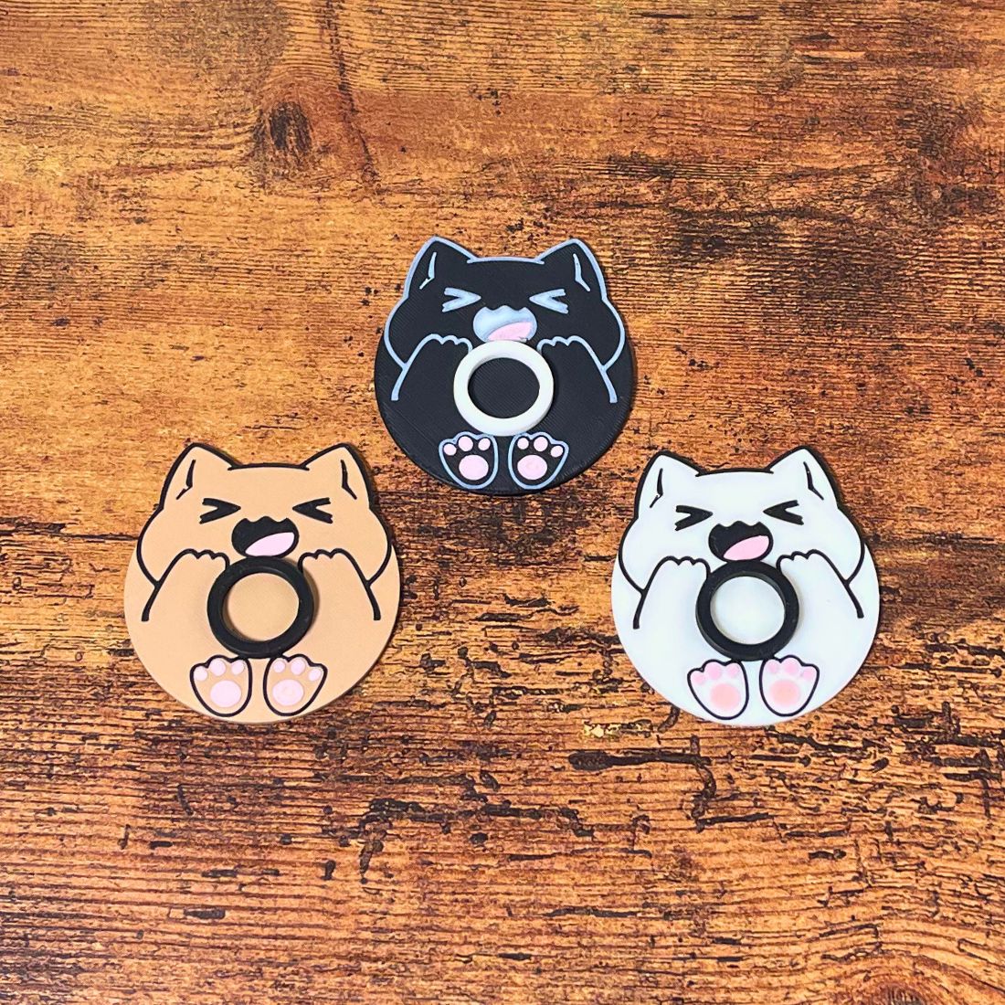 Cute chonk cat lip balm stands in three colors including beige, white, and black