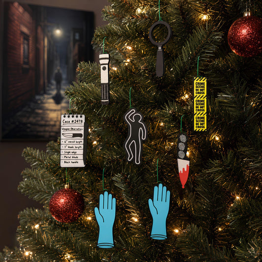 True crime ornaments hanging on a lit Christmas tree with red glitter baubles