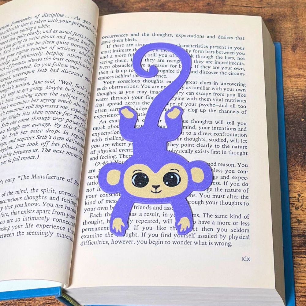 Fun purple monkey bookmark inside of a book