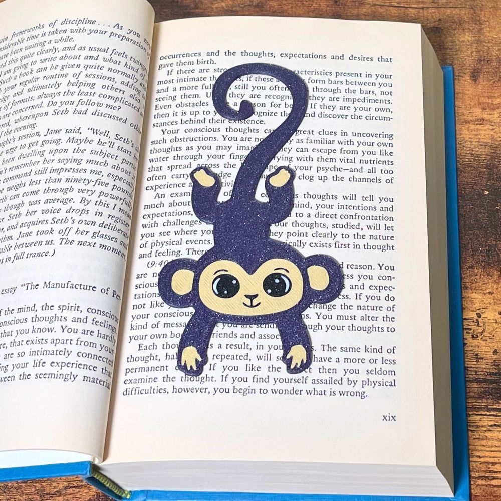 Fun purple monkey bookmark inside of a book