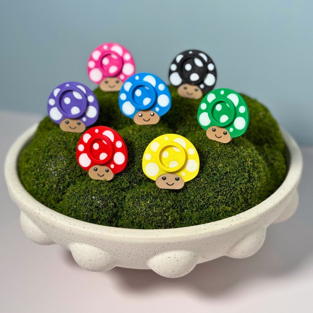 Seven color options for the mushroom lip balm stands including black, red, yellow, green, blue, pink, and purple.