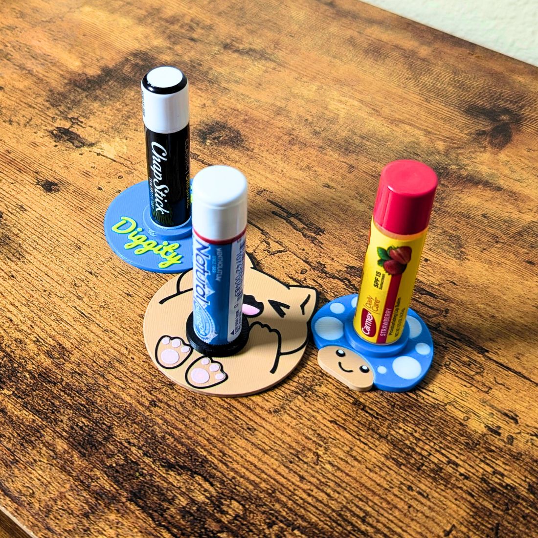 Video showing how the lip balm stands work. Not tipping over when sliding across a table or rolling off your side table under the bed