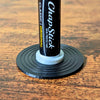 Black and white vinyl record lip balm stand holding a chapstick up