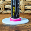 White and pink vinyl record lip balm stand holding a chapstick up