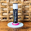 White and pink vinyl record lip balm stand holding a chapstick up