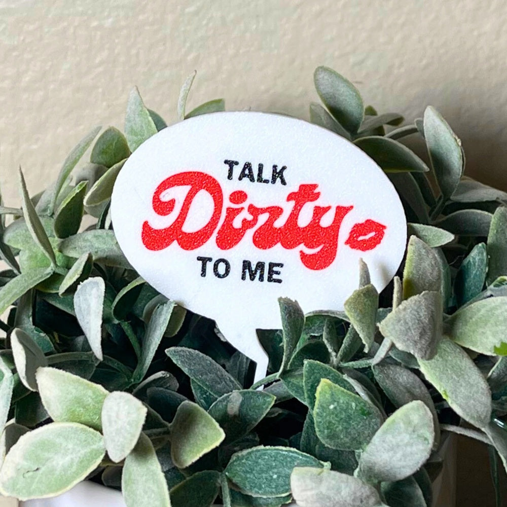 The punny Talk Dirty to Me plant stake in a houseplant closer up