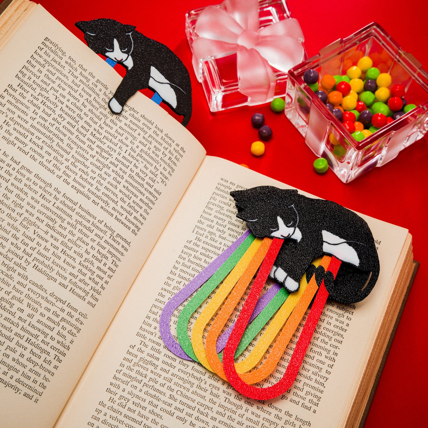 Colorful tuxedo cat bookmarks in multiple colors laying in a book