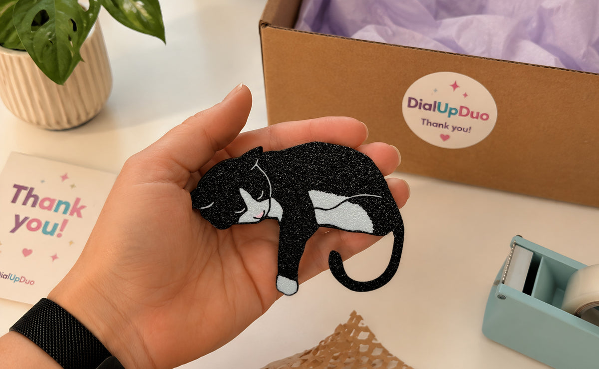 DialUpDuo packaging with a tuxedo cat gift and thank-you card