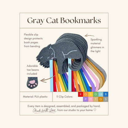 Gray cat bookmarks with colorful clips on a beige background