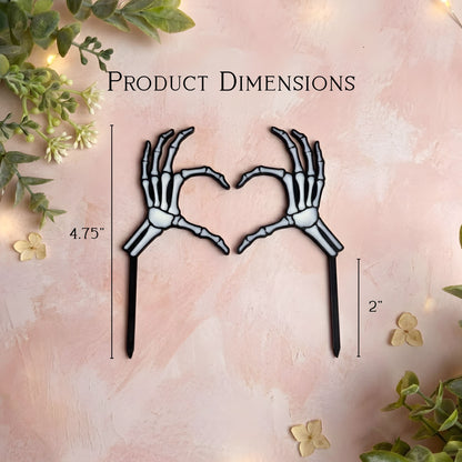 Skeleton hands forming a heart shape with product dimensions on a decorative background.