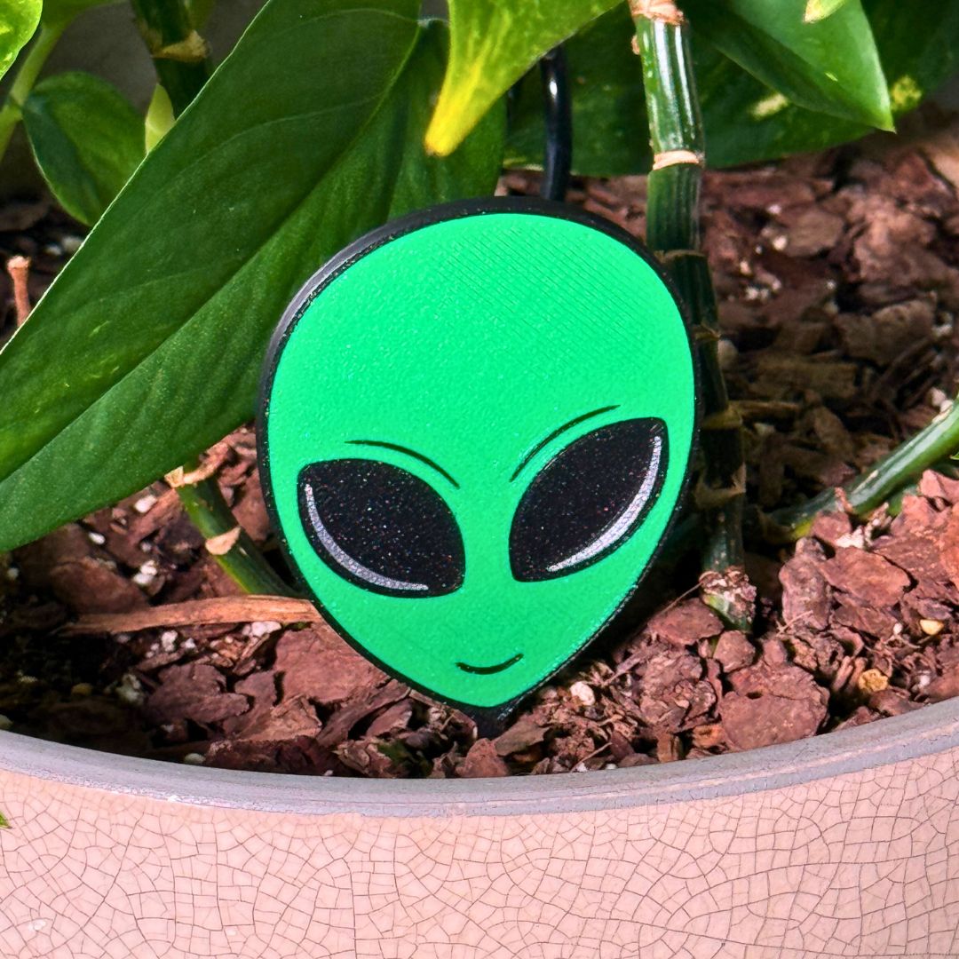 Fun alien head plant stake in a houseplant