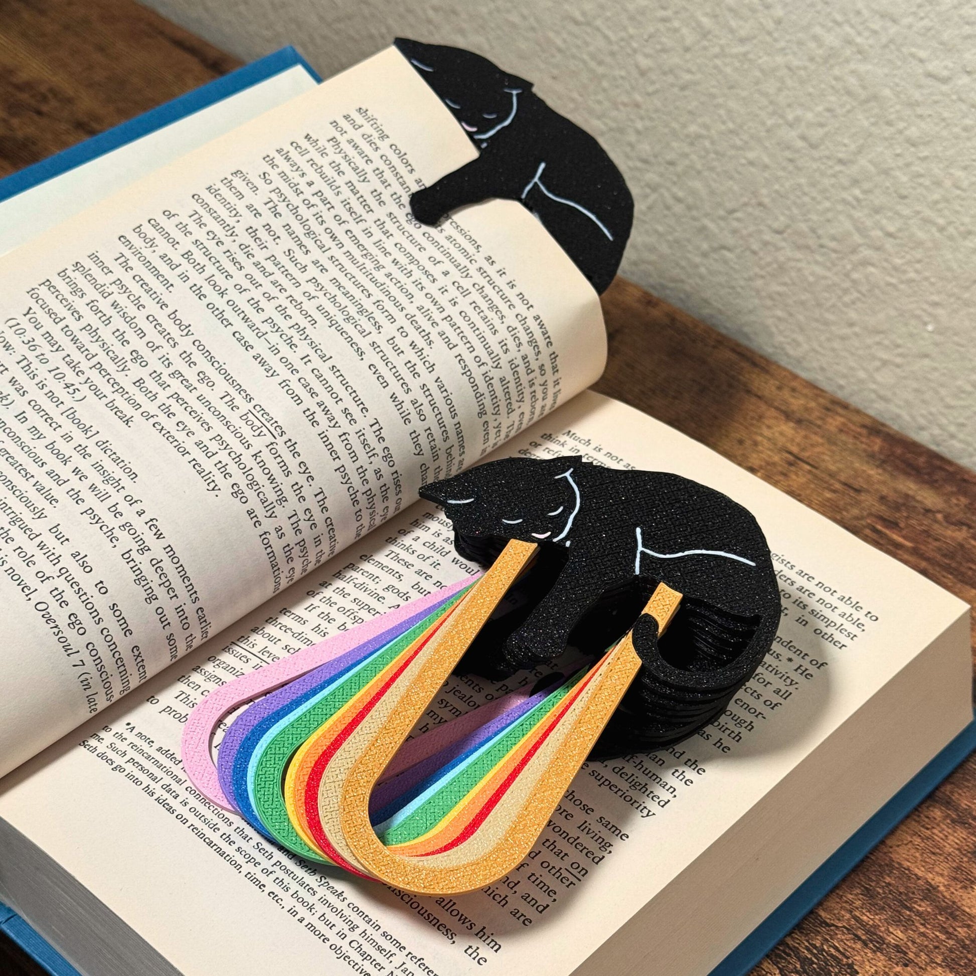 Close up of adorable black cat-themed bookmarks in eleven color variations