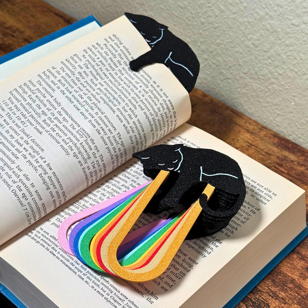 Close up of adorable black cat-themed bookmarks in eleven color variations