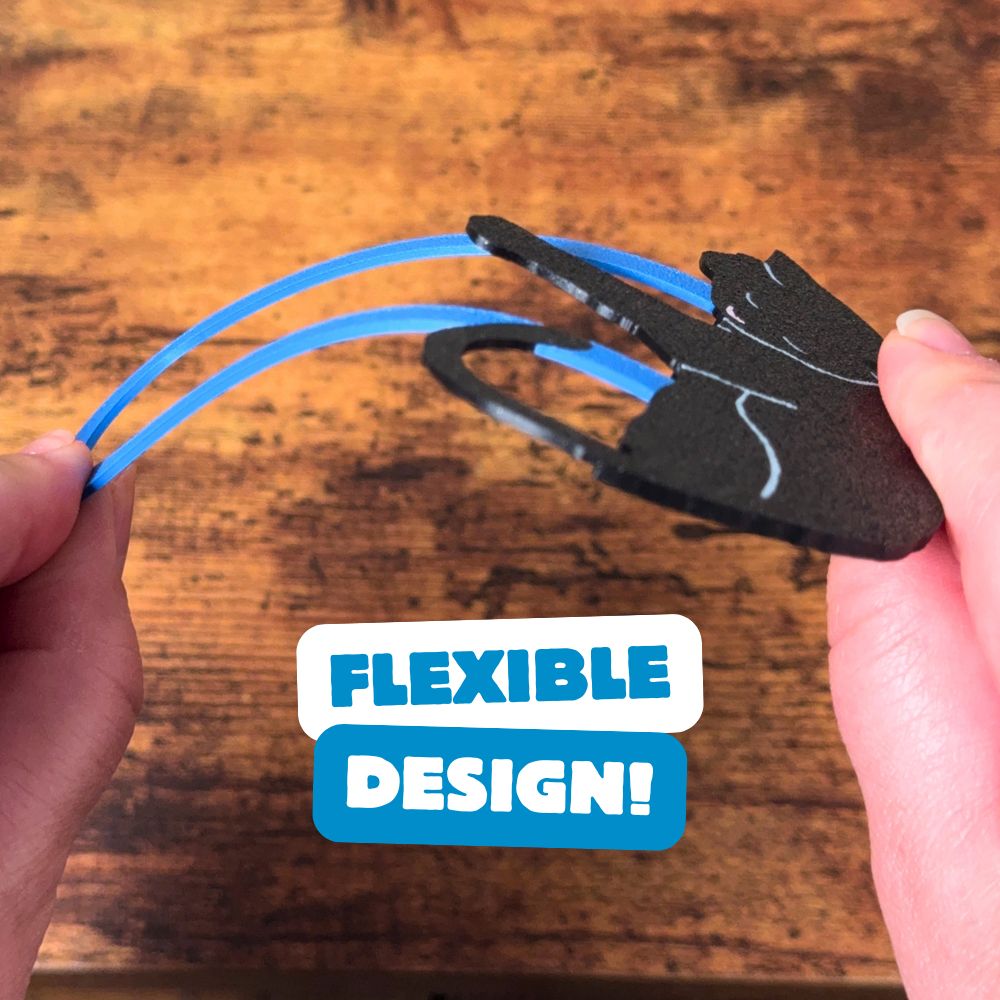 Black cat bookmark being bent, showing off its flexible design