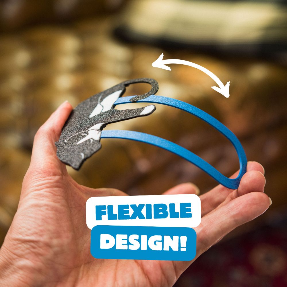 Tuxedo cat bookmark being bent, showing off its flexible design