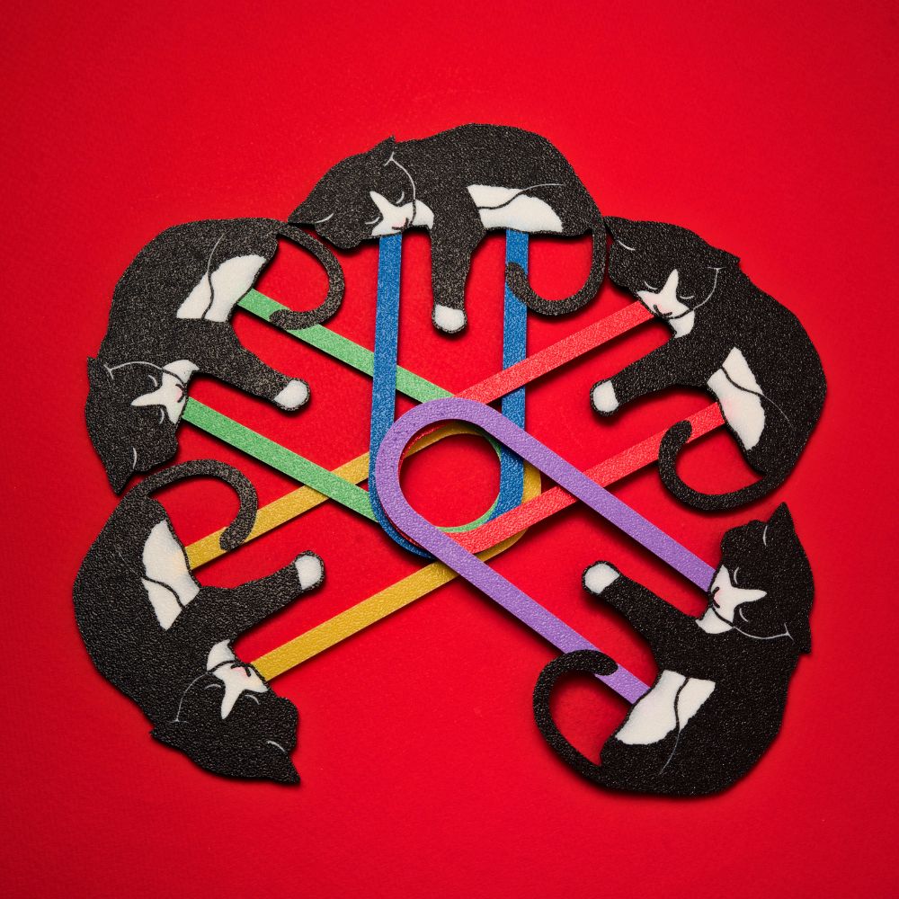 Tuxedo cat bookmarks shown in 5 out of the 11 different colors available including red, gold, green, blue, and purple on a red background in a circular pattern