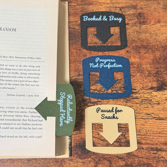 Four custom bookmarks shown in varying color combinations and phrases