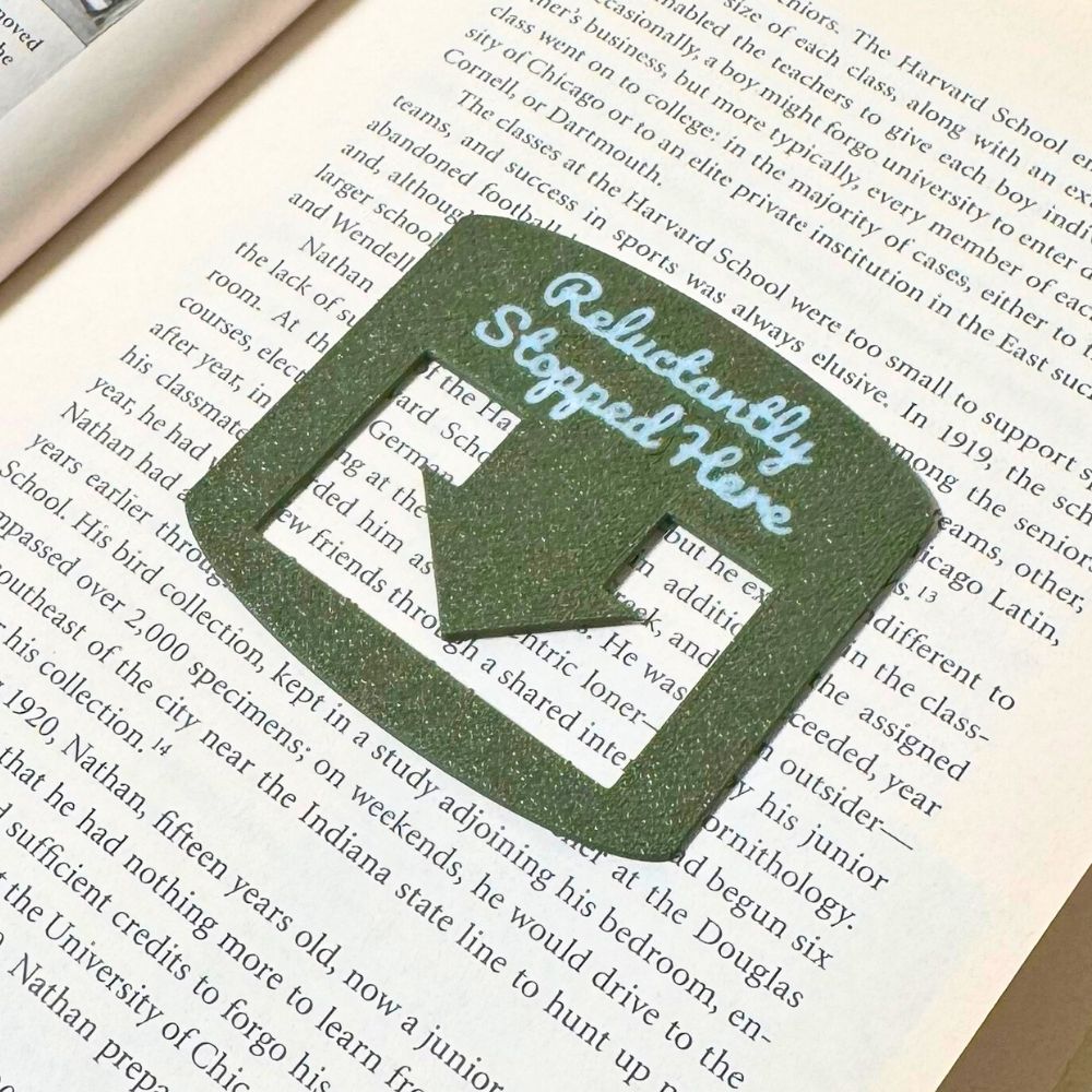 Olive bookmark spot keeper that reads Reluctantly Stopped Here in white font