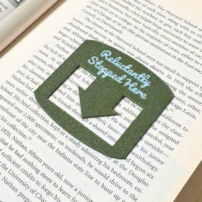 Olive bookmark spot keeper that reads Reluctantly Stopped Here in white font