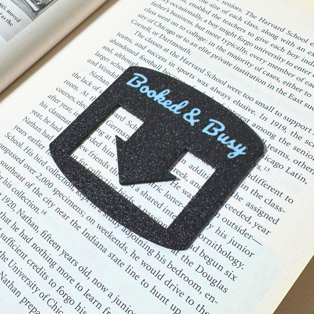 Black bookmark spot keeper that reads Booked & Busy in white font