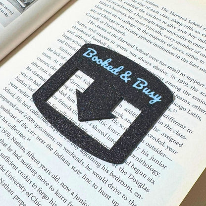 Black bookmark spot keeper that reads Booked & Busy in white font