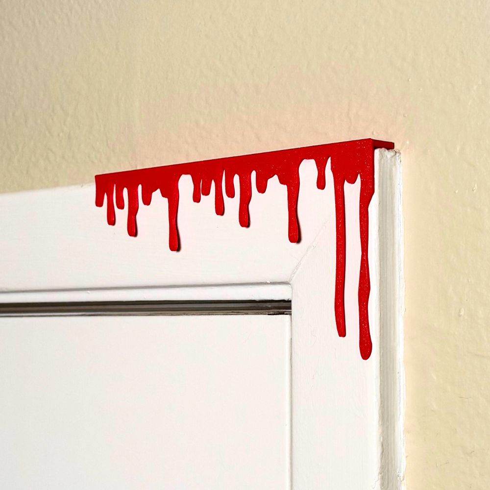 Red paint dripping door corner wall art hanging from the right side of the door