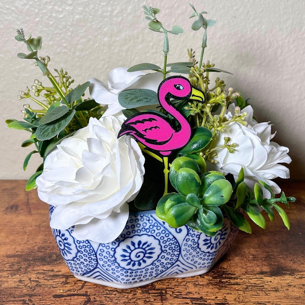 Fun flamingo plant stakes shown in a flower arrangement