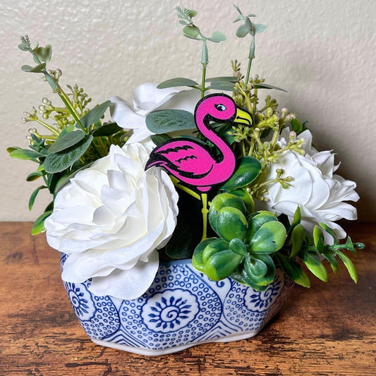 Fun flamingo plant stakes shown in a flower arrangement