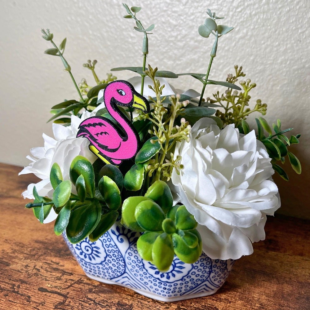 Fun flamingo plant stakes shown in a flower arrangement