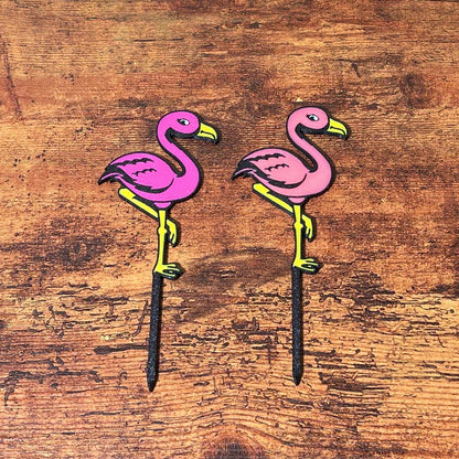 Fun flamingo plant stake shown in both color variations
