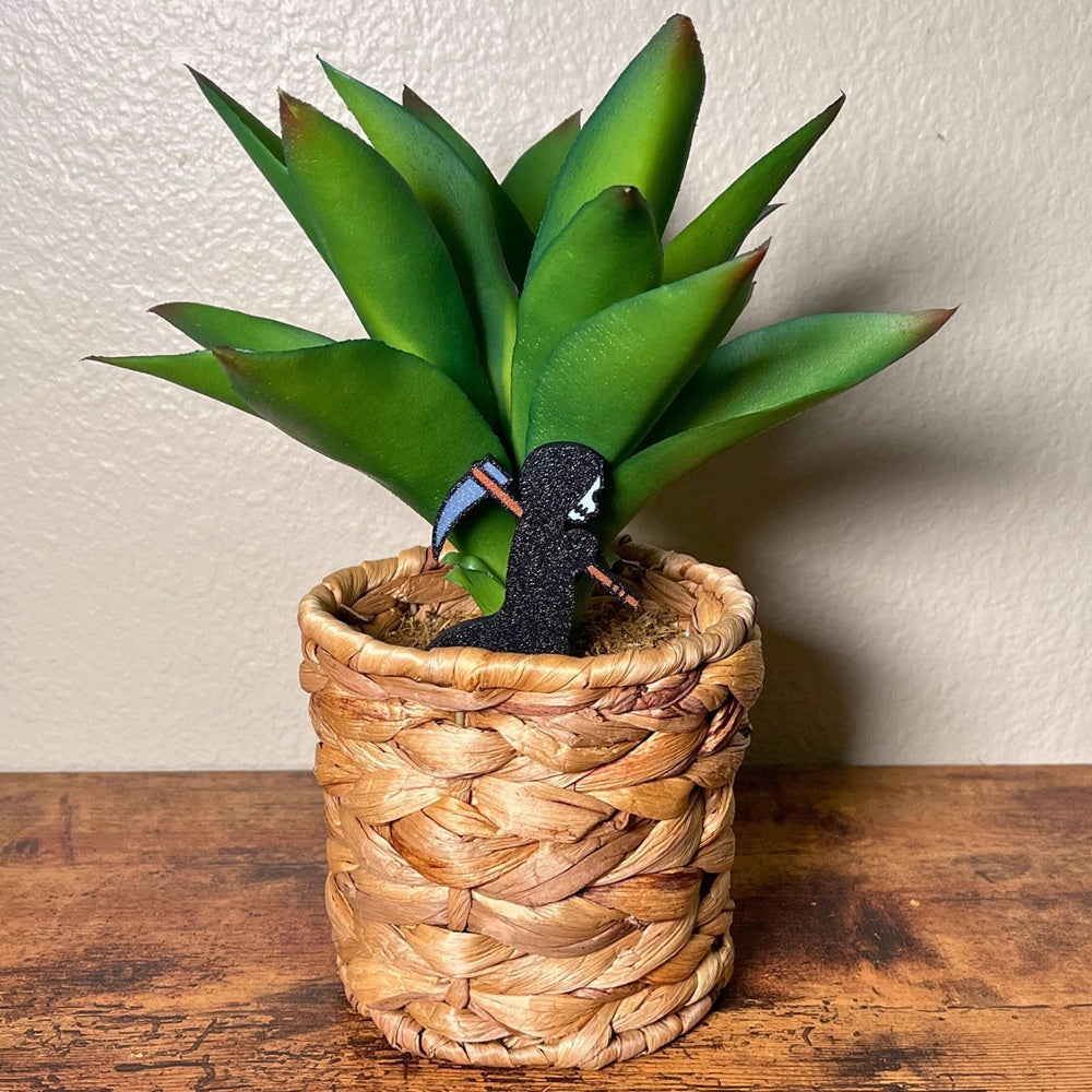Cute little grim reaper plant decor in a houseplant