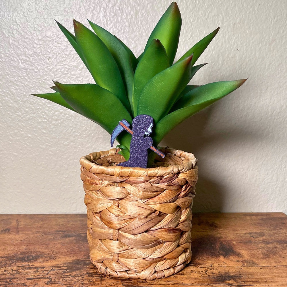 Cute little grim reaper plant decor in a houseplant