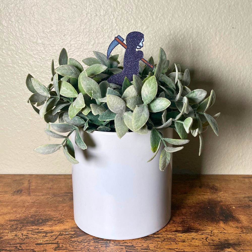 Cute little grim reaper plant decor in a houseplant