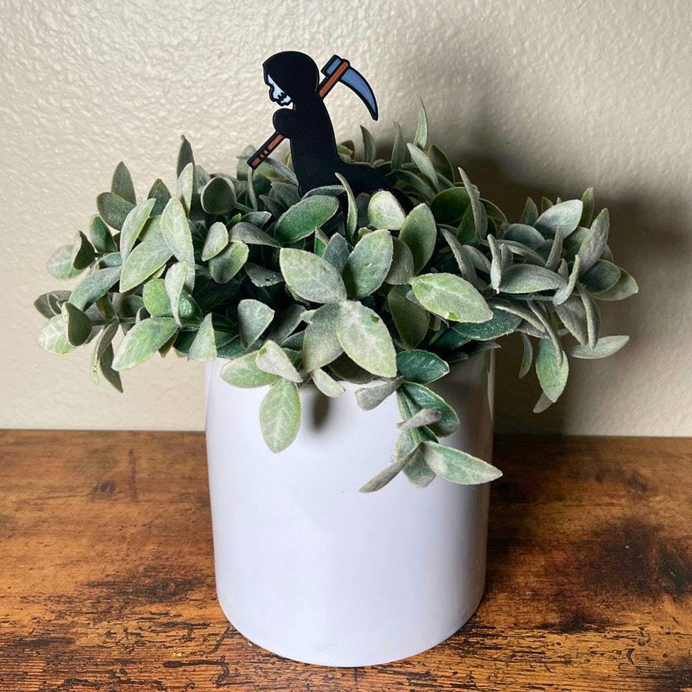 Cute little grim reaper plant decor in a houseplant