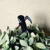 Cute grim reaper plant stake in a houseplant
