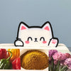 Adorably cute Kawaii cat bookmark peeking out of a book