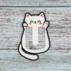 Cute kawaii style cat bookmark on a blue wooden surface