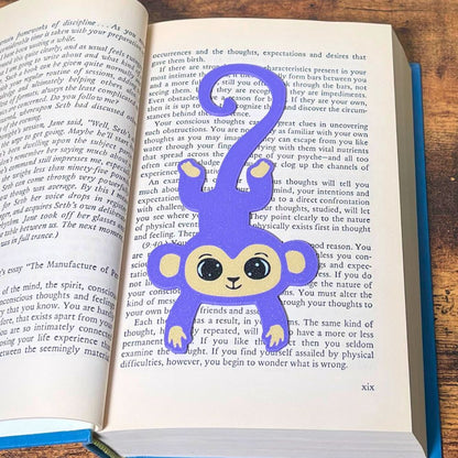 Fun purple monkey bookmark inside of a book