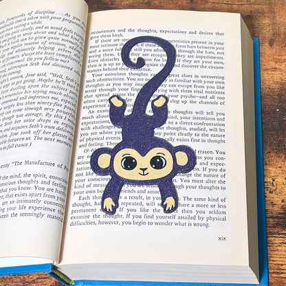 Fun purple monkey bookmark inside of a book