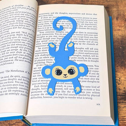 Fun blue monkey bookmark inside of a book