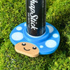 Happy little mushroom lip balm holder in cyan blue on moss holding a chapstick up