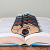 All 4 fur color variations for the single color adorable sleeping puppy dog book page holders shown in a book from the front view