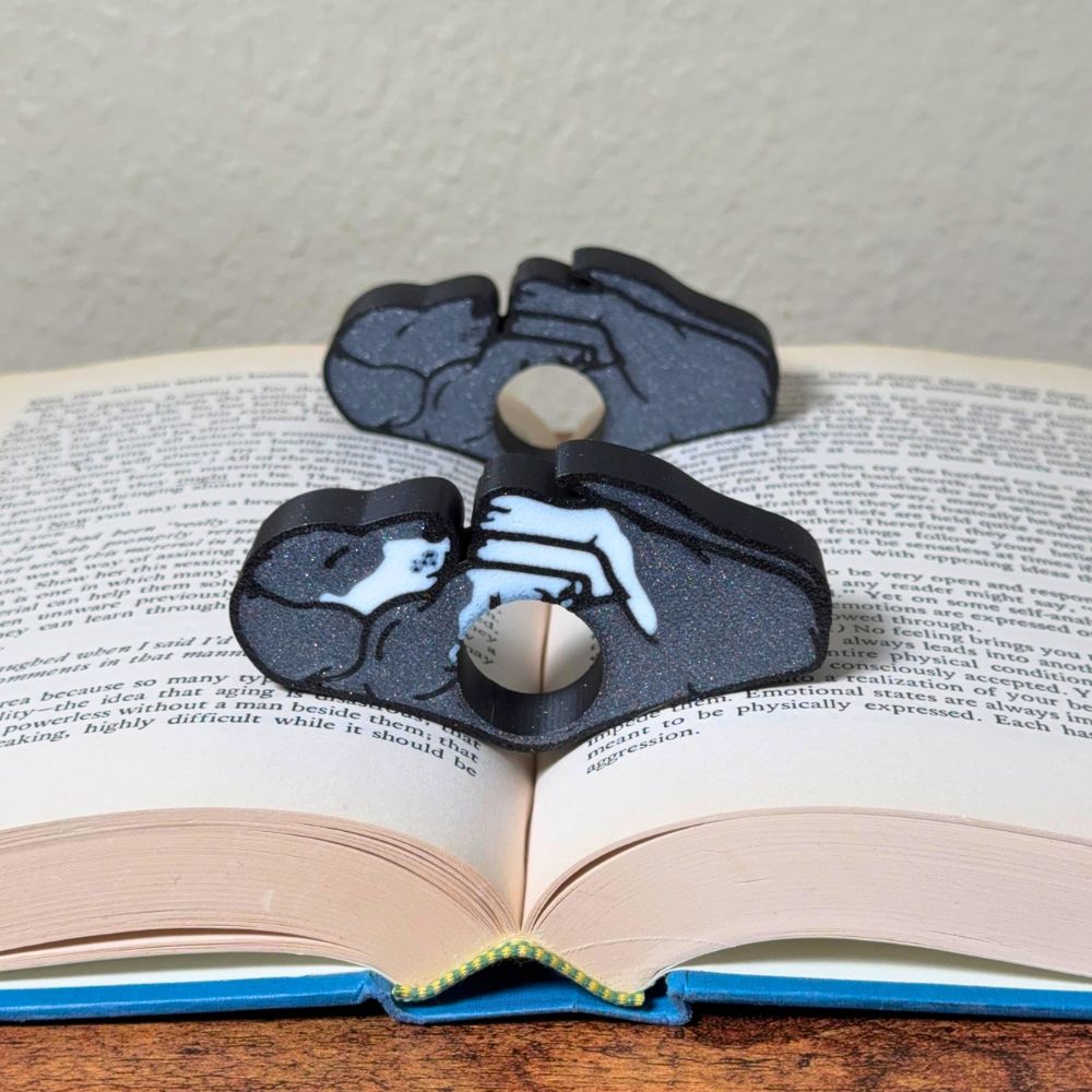 Adorable sleeping gray and white dog book page holders shown in a book