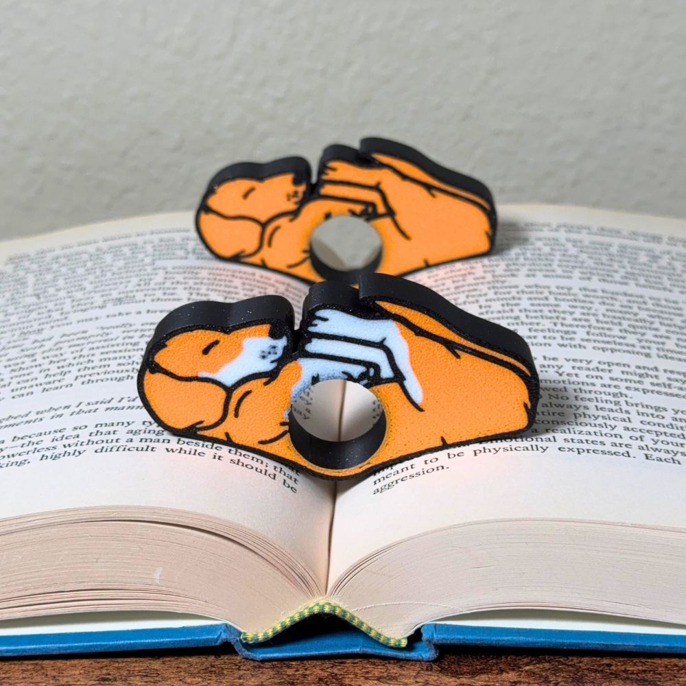 Adorable sleeping orange and white dog book page holders shown in a book