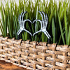 Skeleton bone hands in a heart shape inside of a houseplant