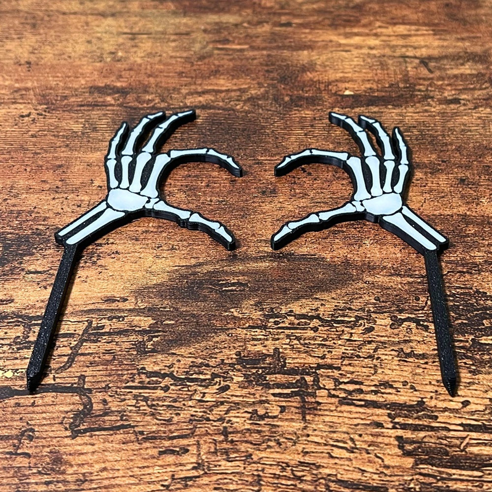 Skeleton bone plant stakes in a heart shape laying flat on a wooden surface