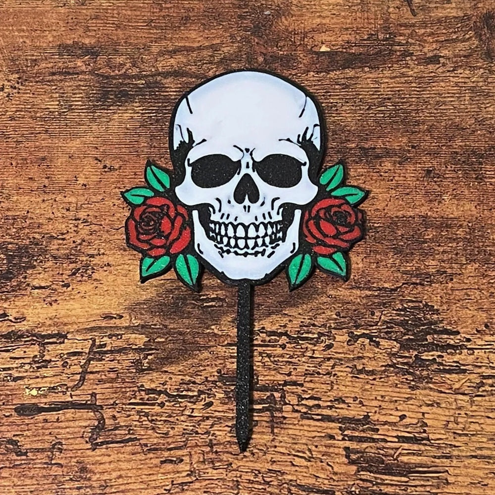 Gothic skull head with red roses shown on a wooden surface