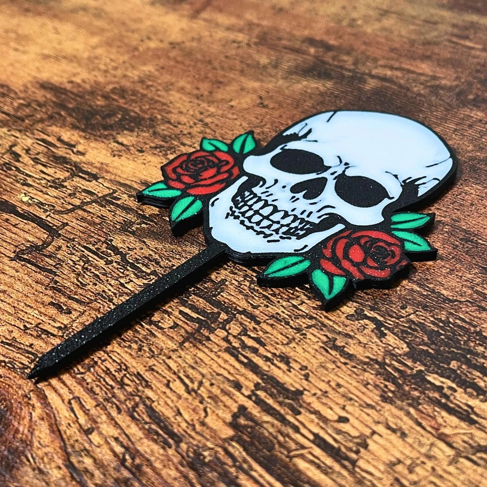 Gothic skull head with red roses shown on a wooden surface
